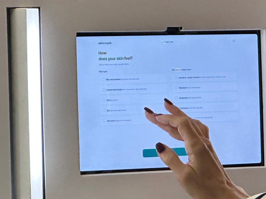 A visitor tapping the skincoach screen