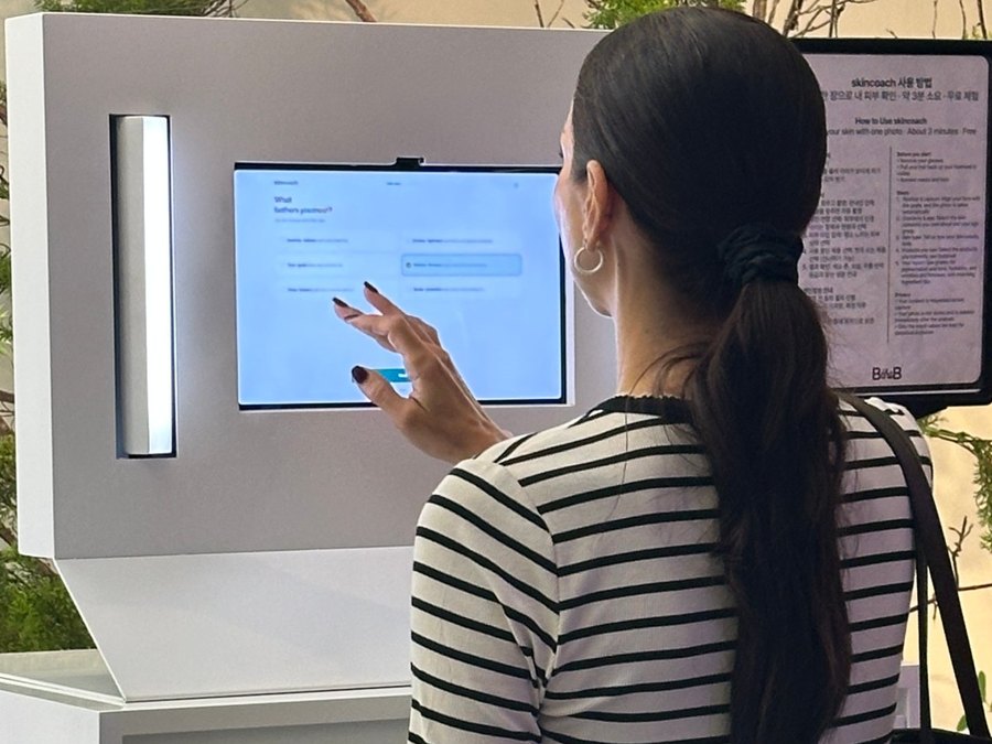 A visitor using the skincoach kiosk